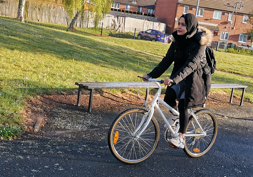 Lubna riding a bike.