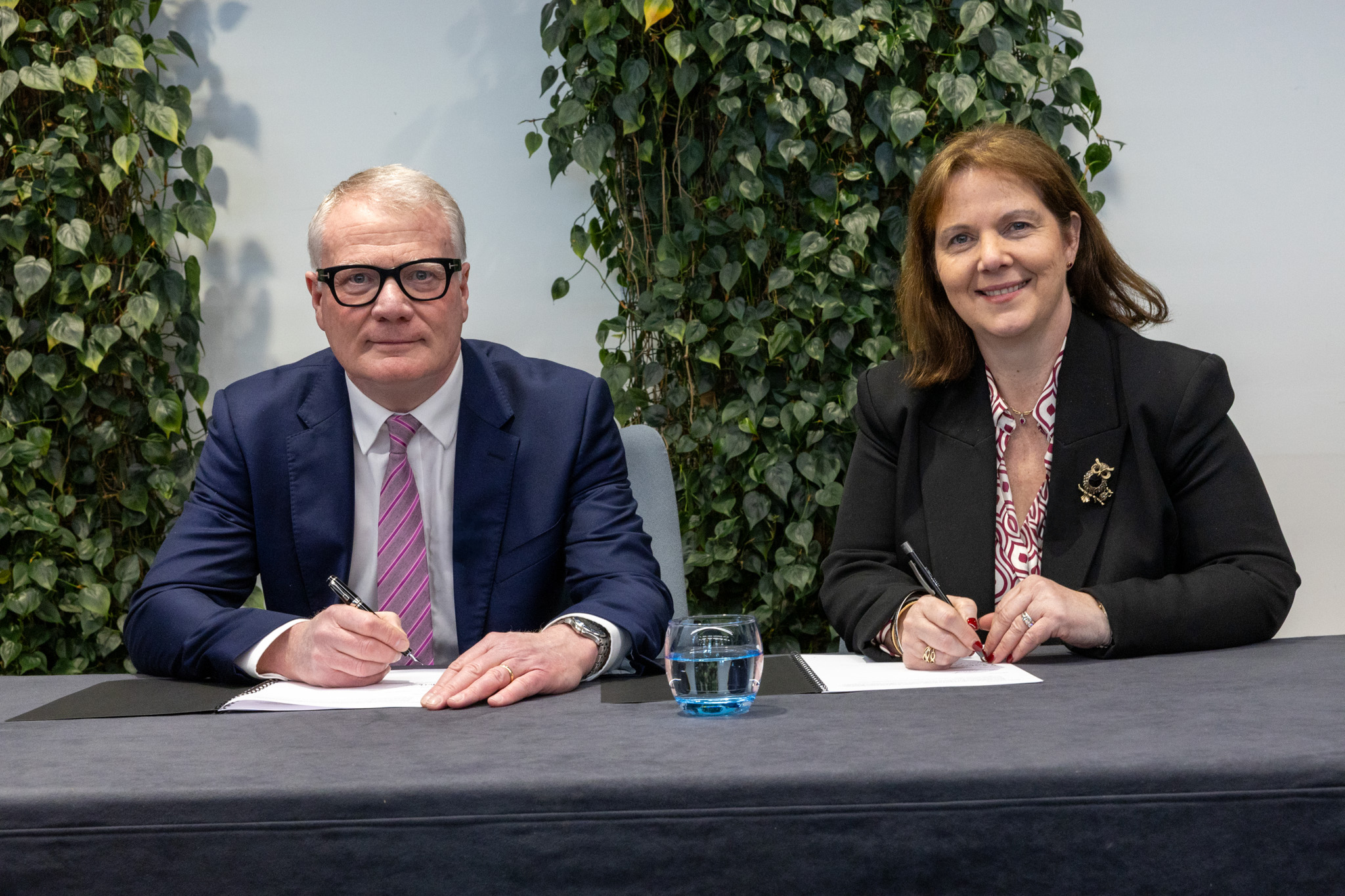 Richard Parker, Mayor of the West Midlands and Claire Ward, Mayor of the East Midlands, signing the West and East Midlands Compact.