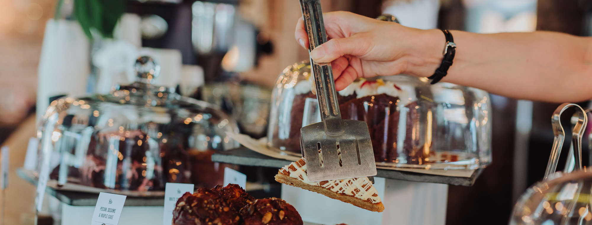 Cake slice being served at a cafe