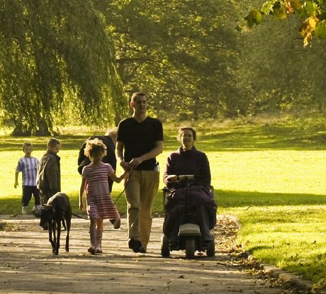 A park with a young family walking on a path