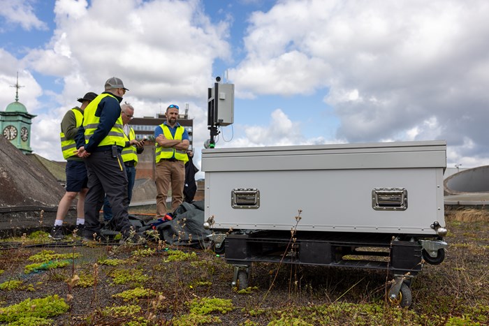 Drone team with the box ready to launch from the rooftop