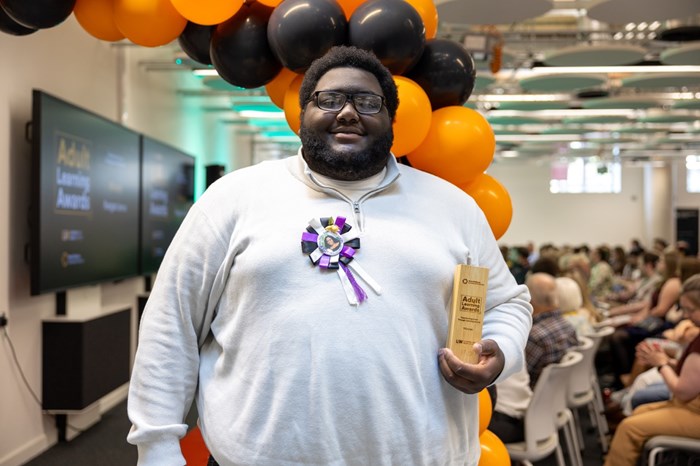 A man holding a trophy.