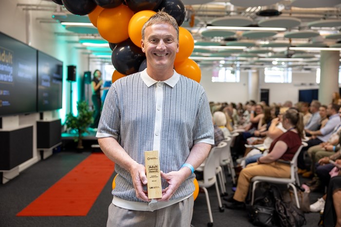 A man holding an award