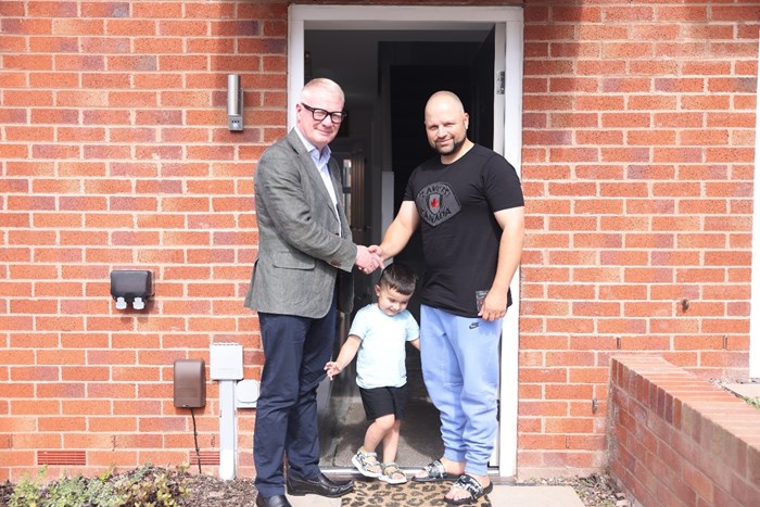 Mayor Richard Parker with one of the new Cookley Works residents Shanjahan Iqbal, aged 39, and his son