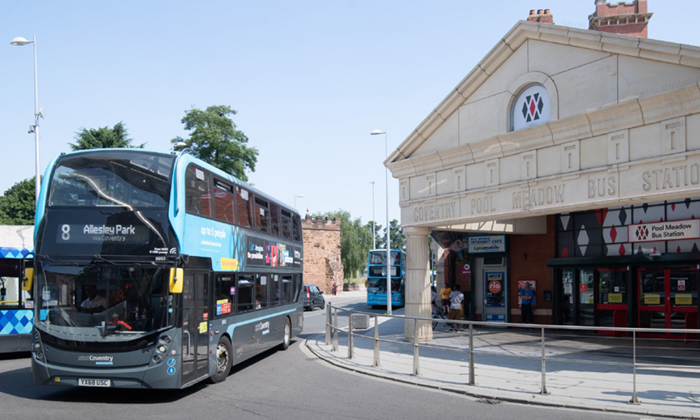 Elegant stonework front of Pool Meadow Bus Station with number 9 double decker passing by
